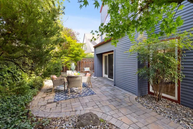a view of a patio with table and chairs and potted plants