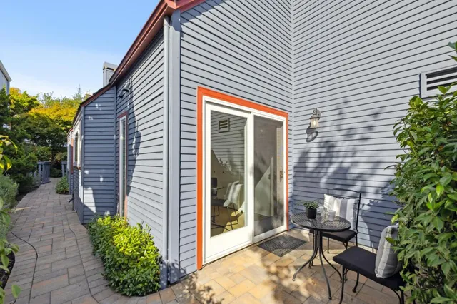 a backyard of a house with outdoor seating