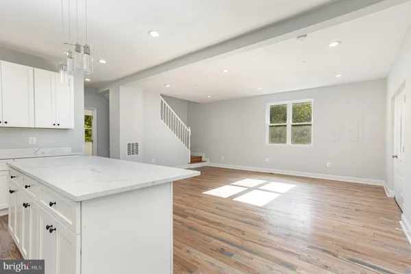 a view of kitchen with wooden floor and electronic appliances