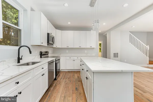 a kitchen with appliances cabinets and a sink