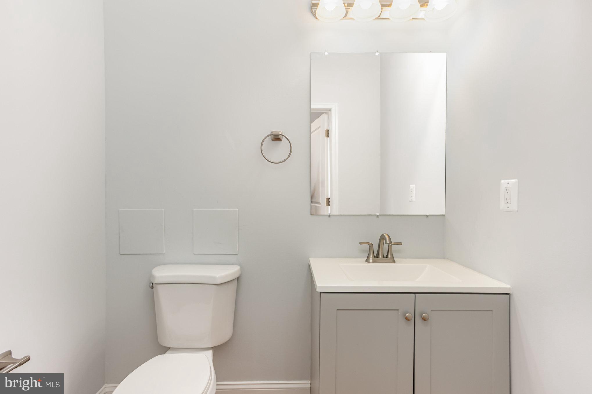 2430 Harris Mill Road Parkton, MD 21120 - Photo 22 of 68 a bathroom with a sink mirror and toilet