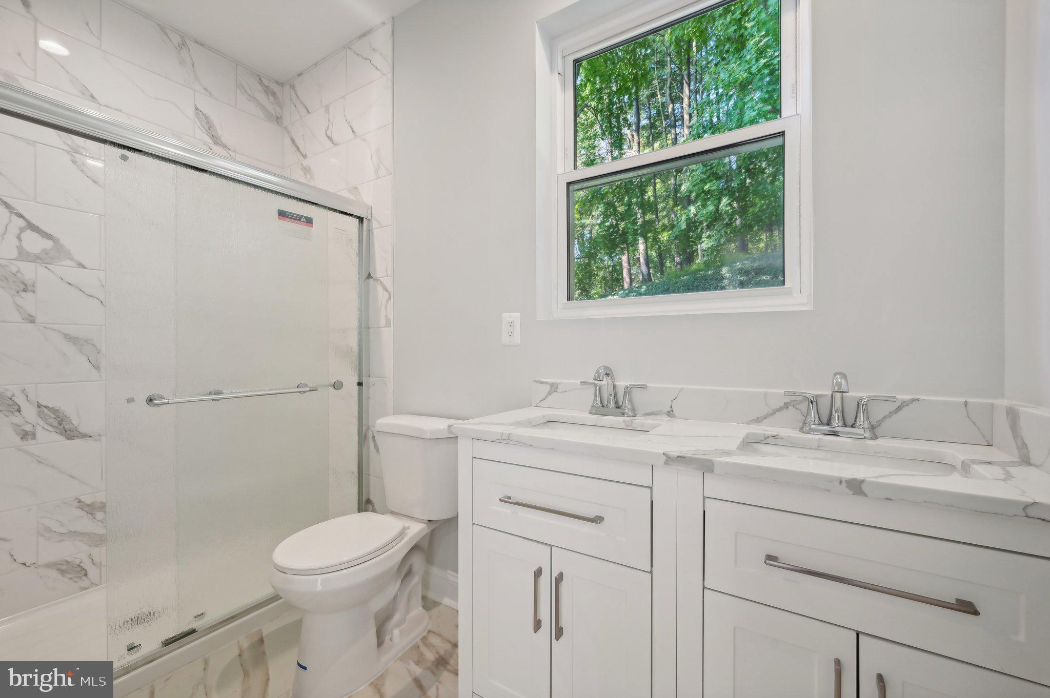 2430 Harris Mill Road Parkton, MD 21120 - Photo 30 of 68 a bathroom with a granite countertop sink mirror vanity and toilet