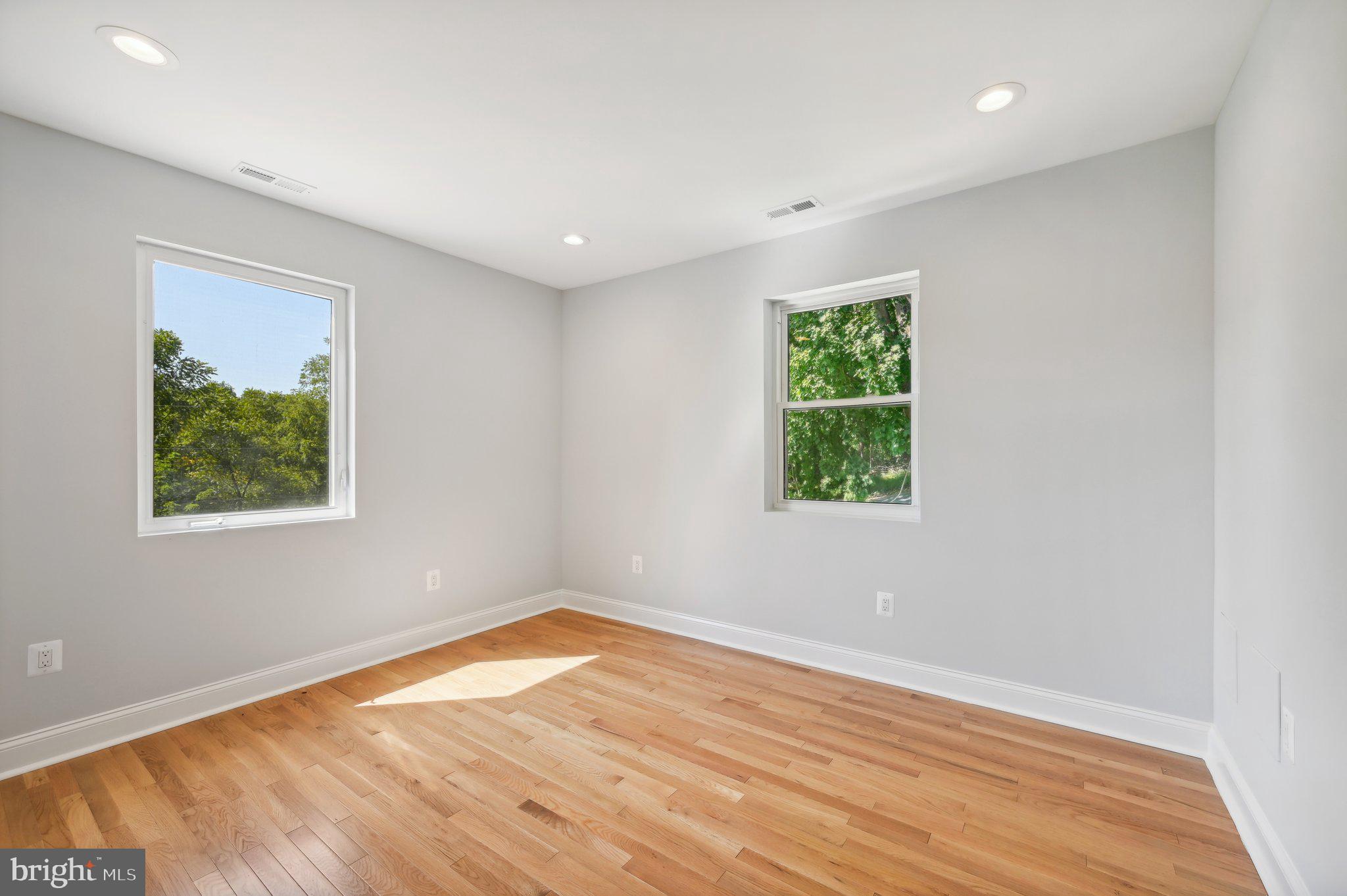 2430 Harris Mill Road Parkton, MD 21120 - Photo 48 of 68 an empty room with wooden floor and windows