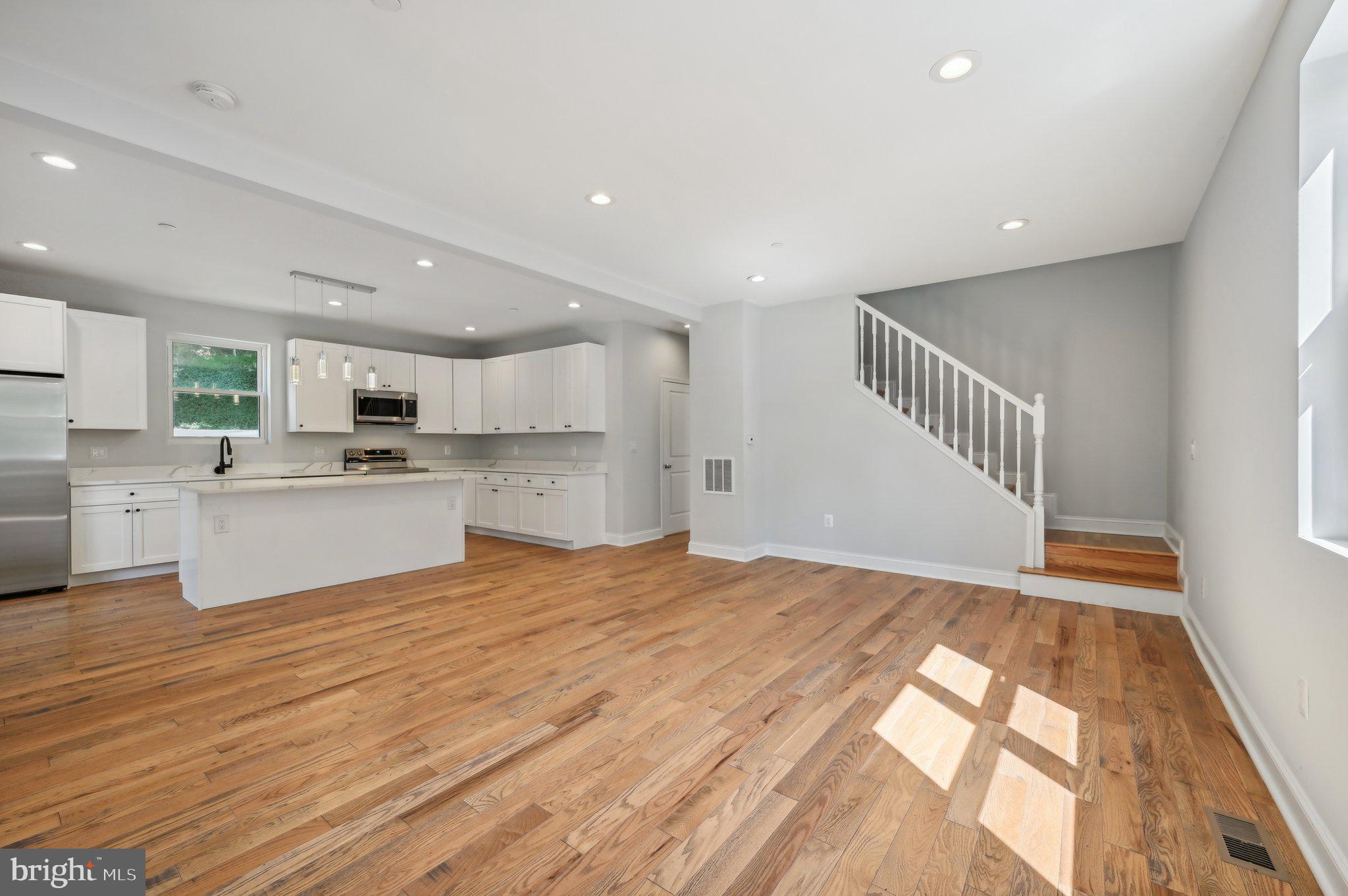 2430 Harris Mill Road Parkton, MD 21120 - Photo 7 of 68 a view of a kitchen with kitchen island a sink wooden floor and a refrigerator