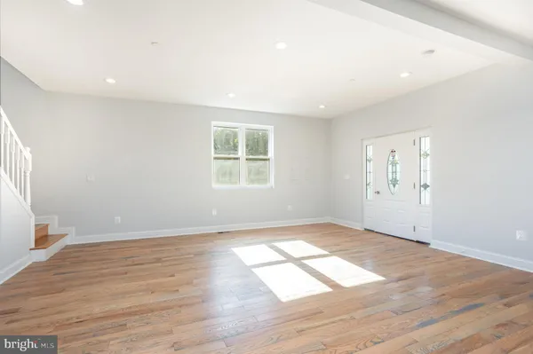 a view of a kitchen with wooden floor and electronic appliances