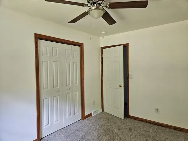 a view of a hallway with a ceiling fan