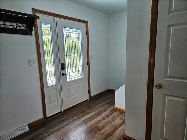 a view of an entryway with wooden floor