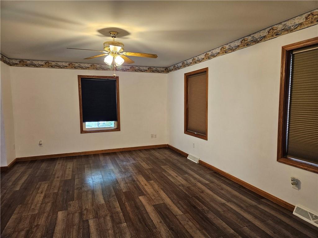 7715 Lamor Road Mercer, PA 16137 - Photo 4 of 30 a view of an empty room with wooden floor and a window