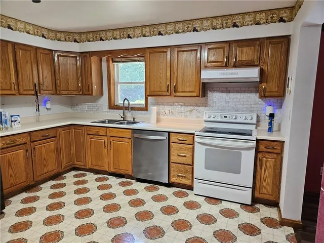 a kitchen with a sink stove and microwave