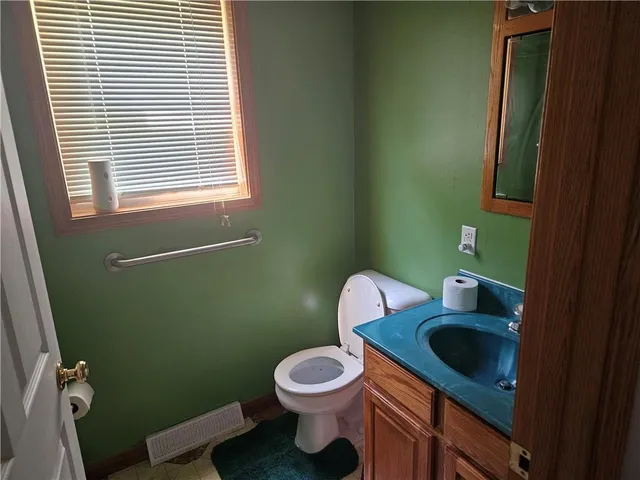 a bathroom with a toilet sink and window