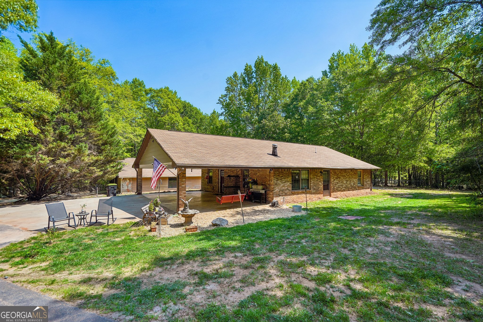 241 Busbin Road Fayetteville, GA 30215 - Photo 4 of 45 a view of a patio with table and chairs under an umbrella
