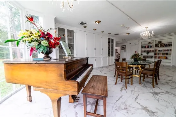a view of a dining room with furniture and a potted plant