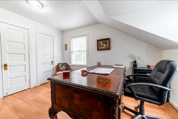 a work room with furniture and wooden floor