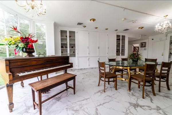 a outdoor kitchen with a table and chairs