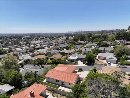 an aerial view of residential houses with city view