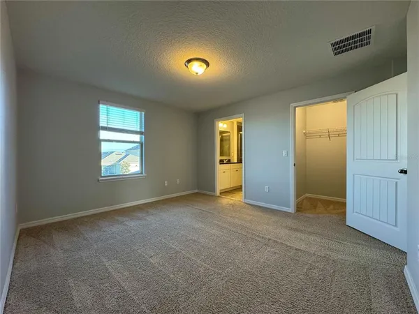 a bathroom with a granite countertop sink a mirror and a shower