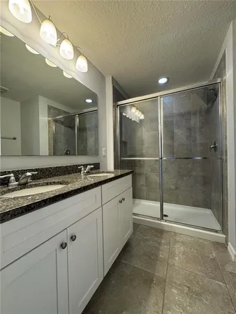 an aerial view of a house with a swimming pool and outdoor seating