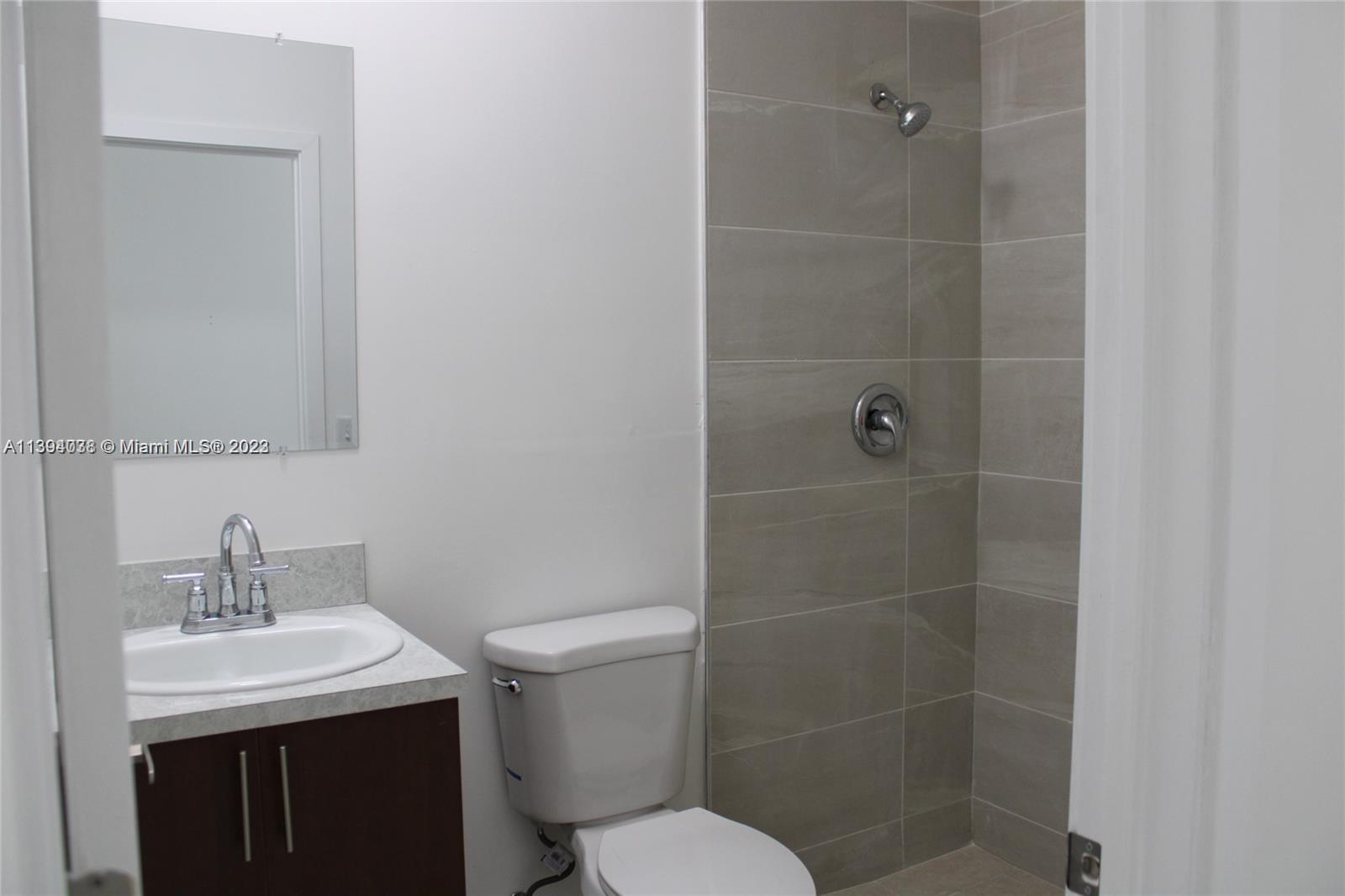 Blanche Ely Pompano Beach, FL 33060 - Photo 14 of 24 a bathroom with a sink toilet and shower