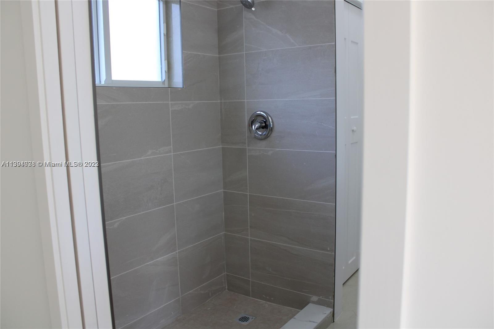 Blanche Ely Pompano Beach, FL 33060 - Photo 16 of 24 a bathroom with a glass shower door