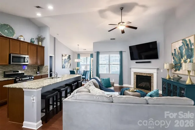 a living room with furniture and a fireplace