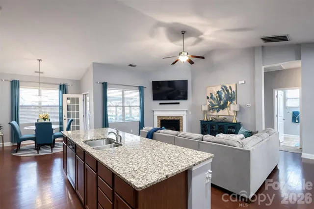 a living room with furniture fireplace and flat screen tv