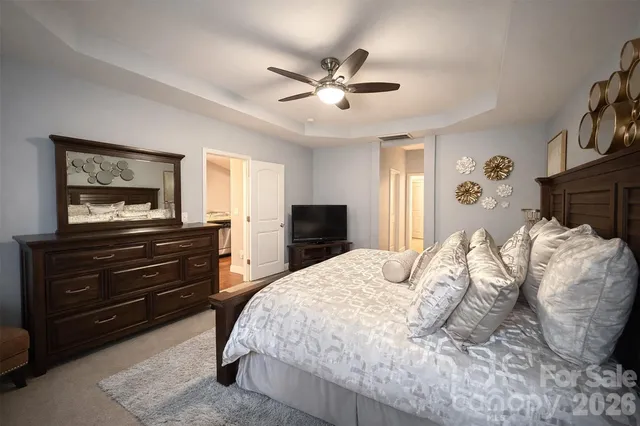 a bedroom with a bed and a chandelier