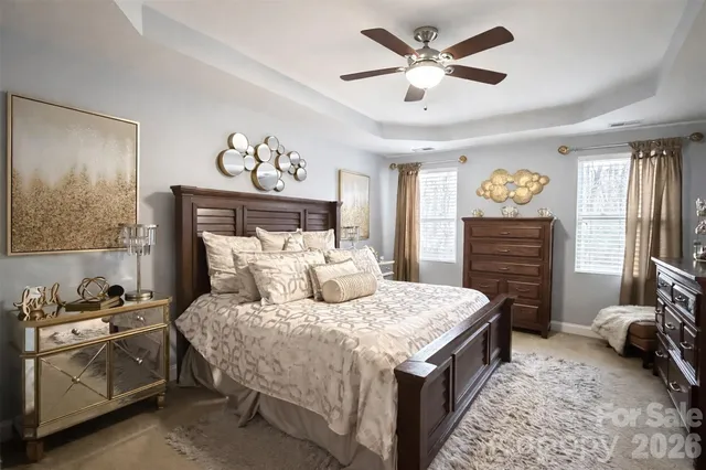 a bedroom with a bed dresser and wooden floor