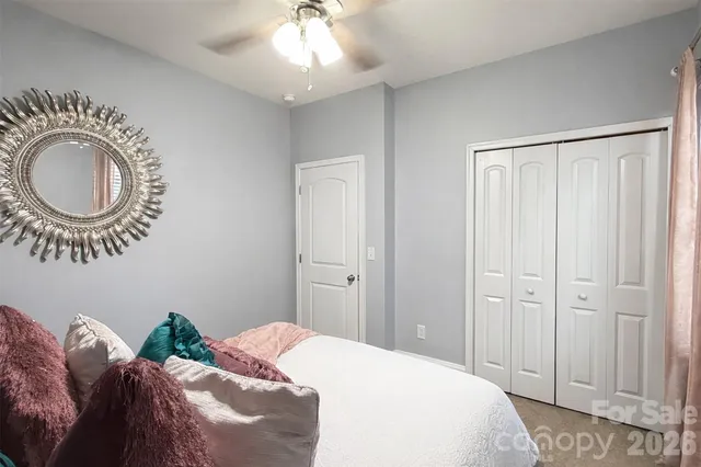 a bedroom with bed and a chandelier