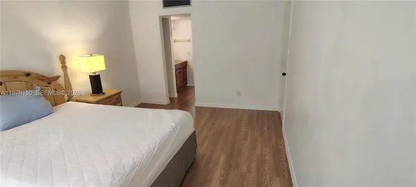 a view of empty room with wooden floor