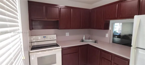 a kitchen with stainless steel appliances a refrigerator and cabinets