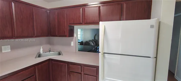 a kitchen with a refrigerator and cabinets