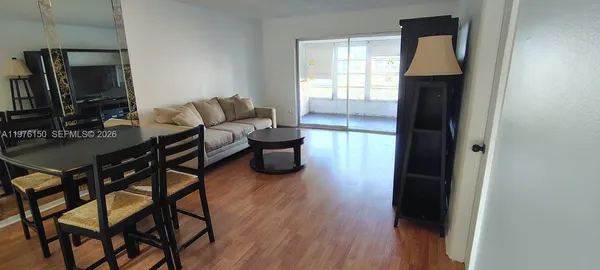 a bedroom with a bed wooden floor and a window