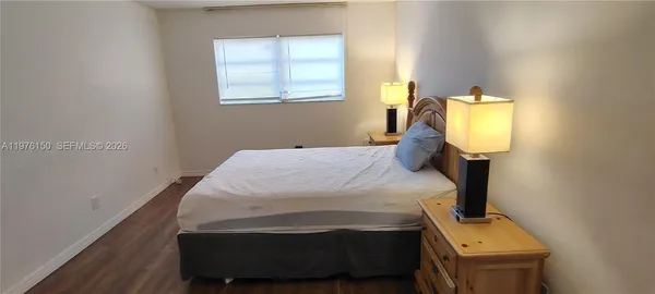 a large bed sitting in a bedroom next to a lamp