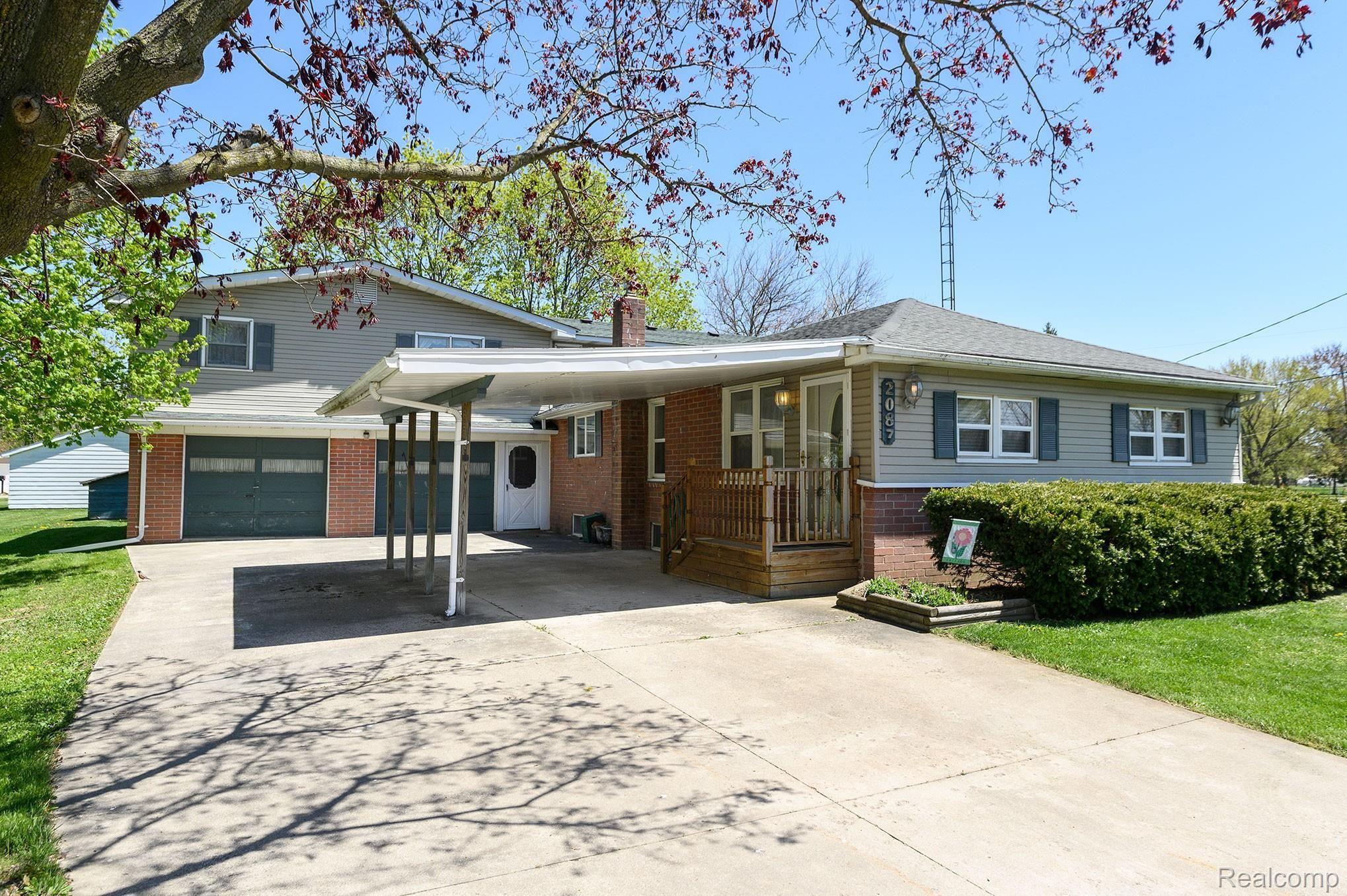 2087 Roland Avenue Flint, MI 48532 - Photo 1 of 22 Front door. Car Port. 2 Car attached garage.