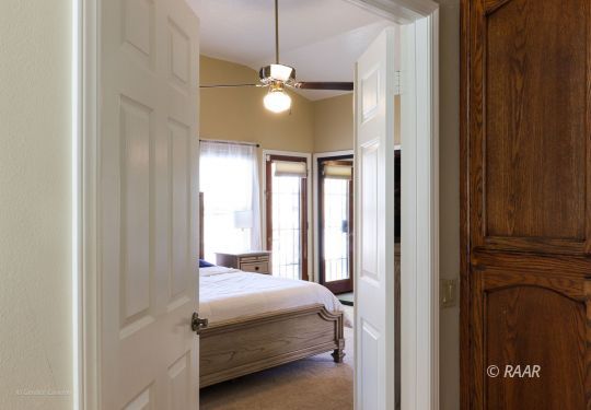 240 West Sequoia Place Ridgecrest, CA 93555 - Photo 23 of 32 a bedroom with a bed and a chandelier