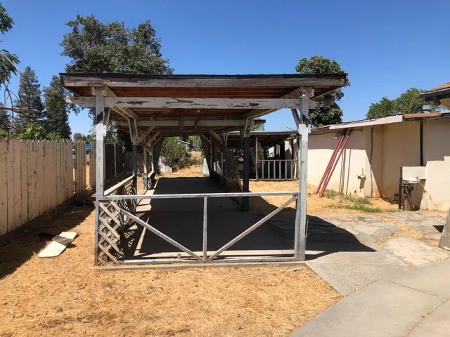 a kitchen with granite countertop a sink a stove and cabinets