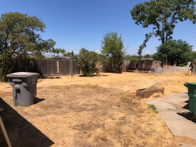 an empty room with wooden floor and a window