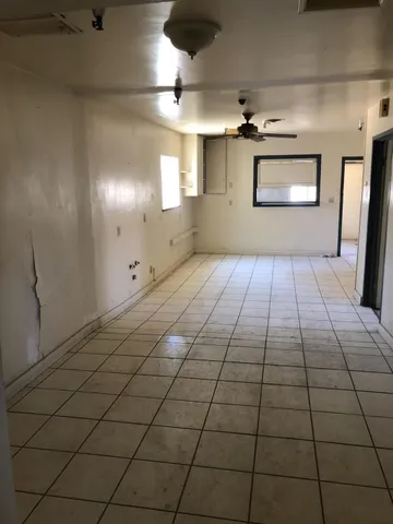 a backyard of a house with table and chairs