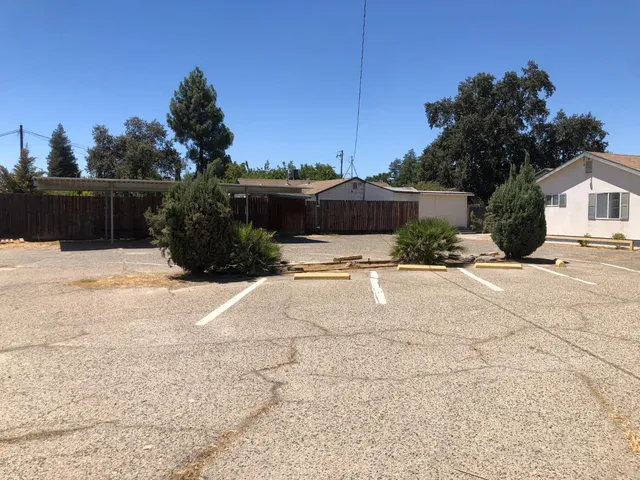 a view of a house with a yard and a garage