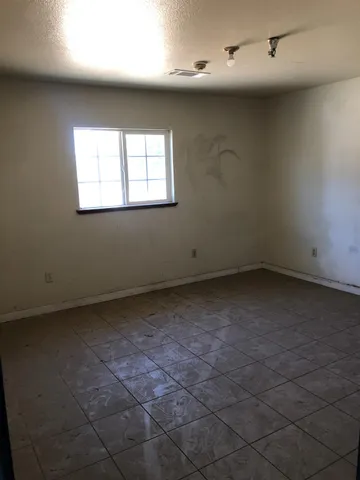 an empty room with a empty space and windows