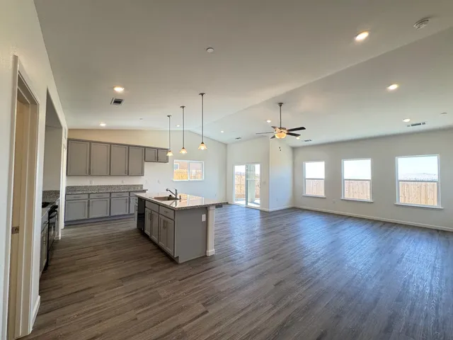 an empty room with closet and ceiling fan