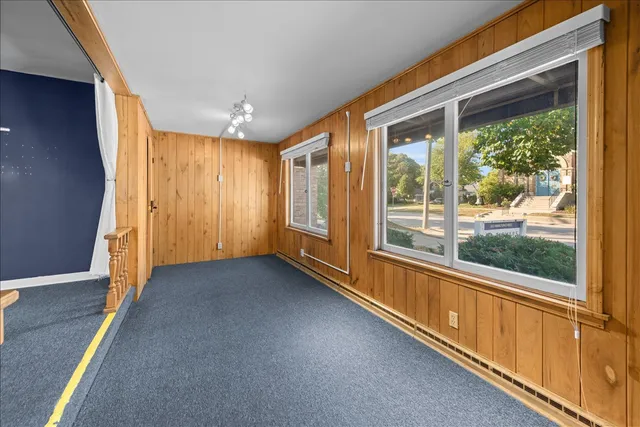 a view of a room with large windows and stairs