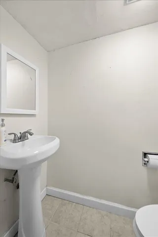 a bathroom with a sink a toilet and mirror