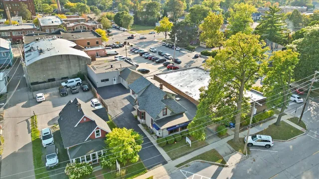 an aerial view of a residential houses with yard