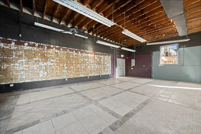 a view of a patio with a table and chairs under an umbrella