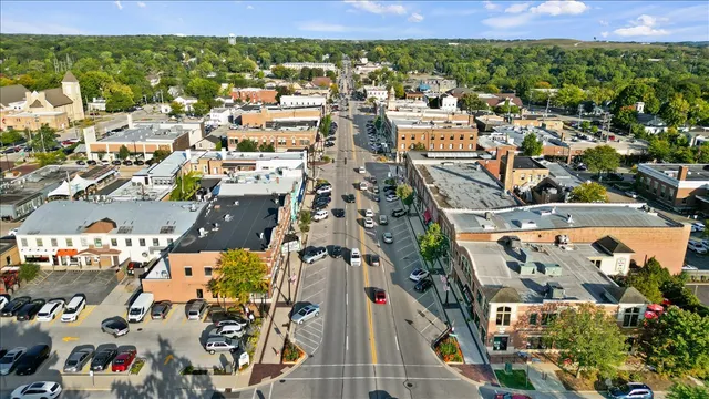 an aerial view of a houses with city view