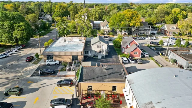 an aerial view of a residential houses with outdoor space