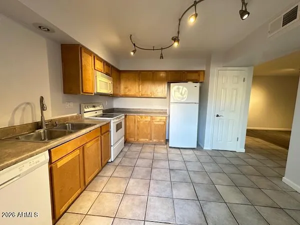 a large kitchen with stainless steel appliances granite countertop a sink and cabinets