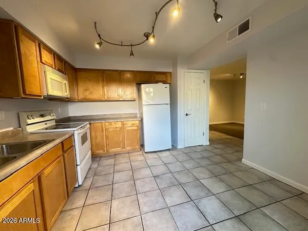 a kitchen with stainless steel appliances granite countertop a sink and cabinets