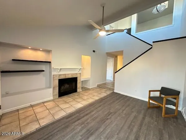 a view of a livingroom with wooden floor and a fireplace